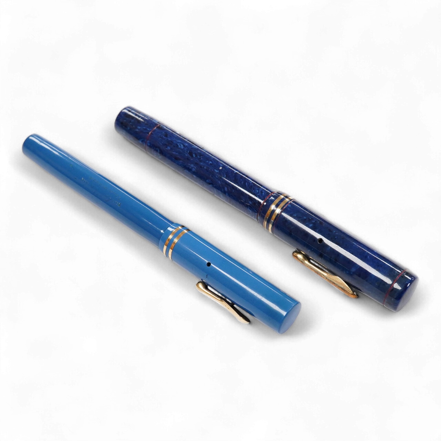Two Conklin Enoura fountain pens in lapis blue (Senior) and a pale blue example
